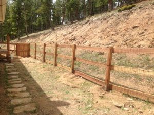 Wood fence with an open weave mesh liner
