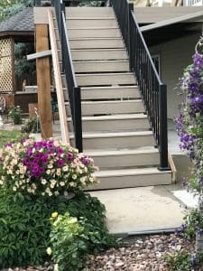 wooden steps leading up with black railing