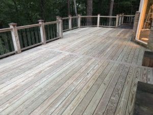 Multy section wooden deck with railing, posts with caps