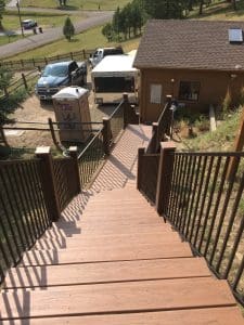 Wooden deck and 3 level steps down an incline