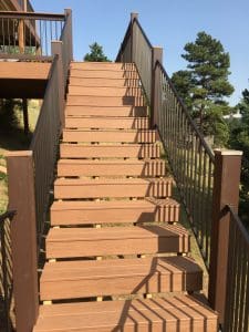 Wooden deck and 3 level steps down an incline