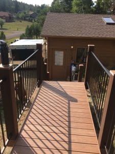 Wooden deck and 3 level steps down an incline