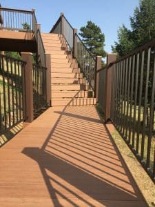 Wooden deck and 3 level steps down an incline