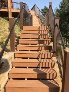 Wooden deck and 3 level steps down an incline