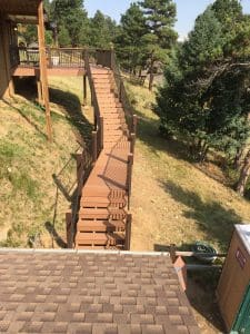 Wooden deck and 3 level steps down an incline