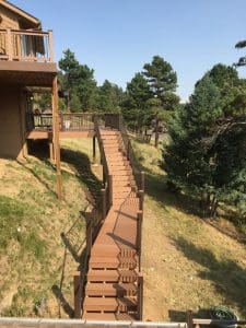 Wooden deck and 3 level steps down an incline