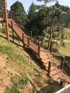 3 Level wooden steps, railing leading down/up an incline