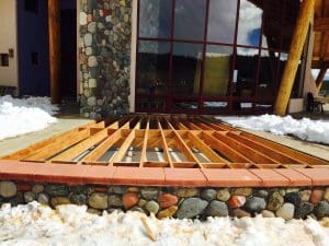 wood decking edged with pavers. Matching rock front facing under deck to match rocks on house