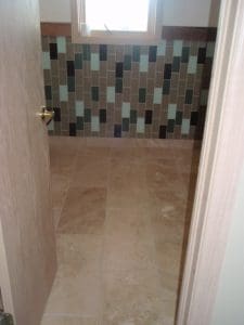 Tiled floors, with vertically tiled walls in bathroom
