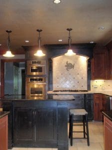 Dark kitchen cabinets with ivory diagonal backsplash