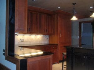 Dark kitchen cabinets with ivory diagonal backsplash