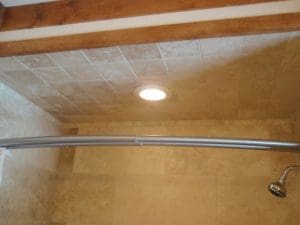 Oak trimmed shower install, and tiled walls, and roof.