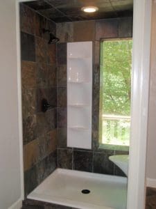 Built-in shelving inside walk- in shower