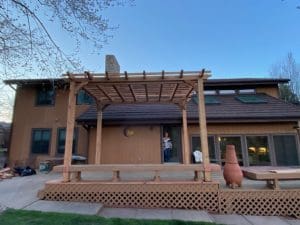 Deck wit arbor and built in bench looking towards the back of house